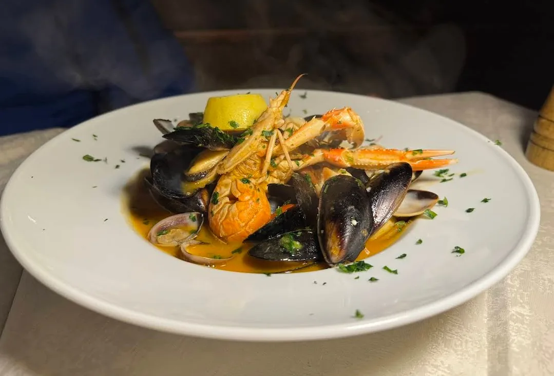 Mussels, clams and scampi steaming in a bowl with lemon